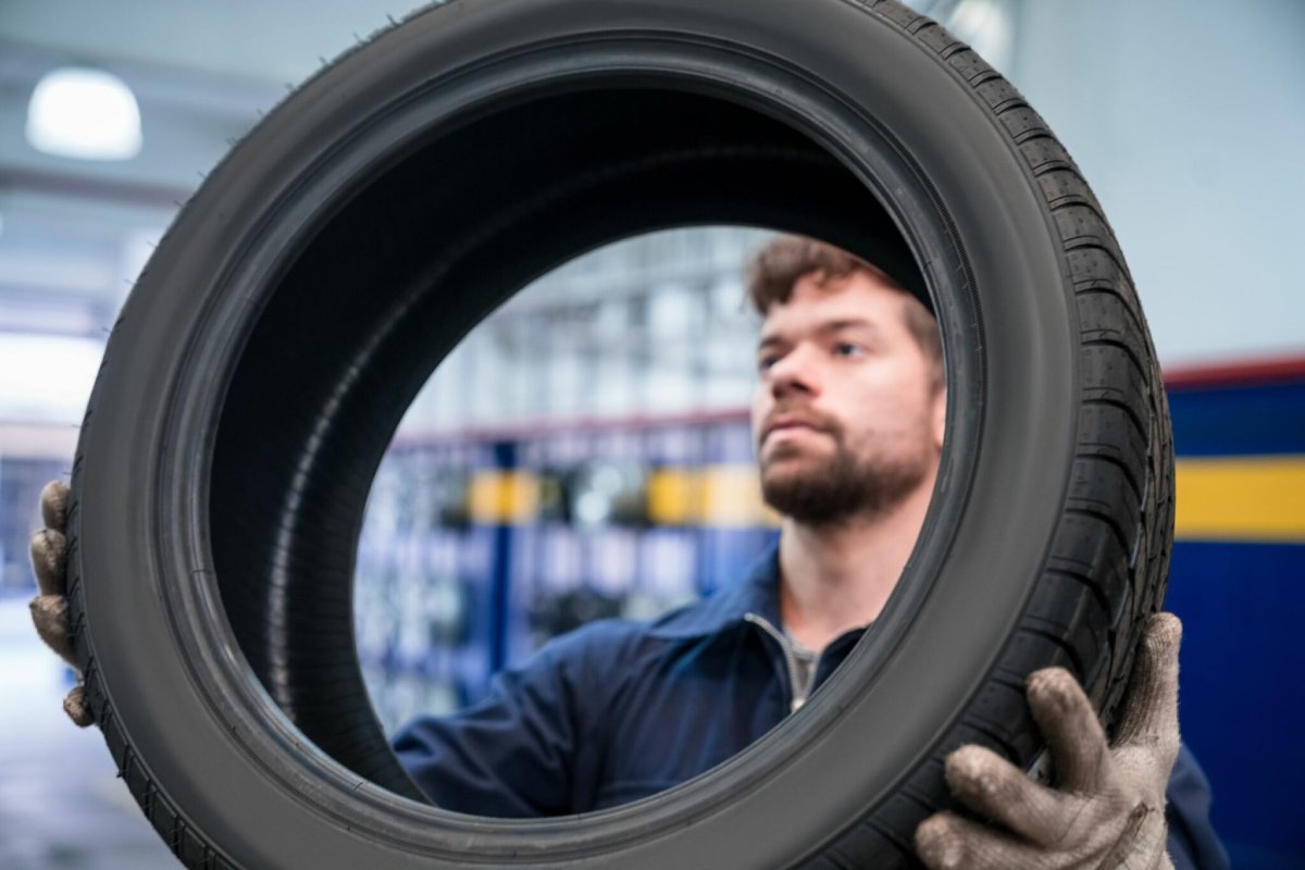 borracheiro analisando pneu Durabilidade dos pneus: veja 5 dicas para o pneu durar mais